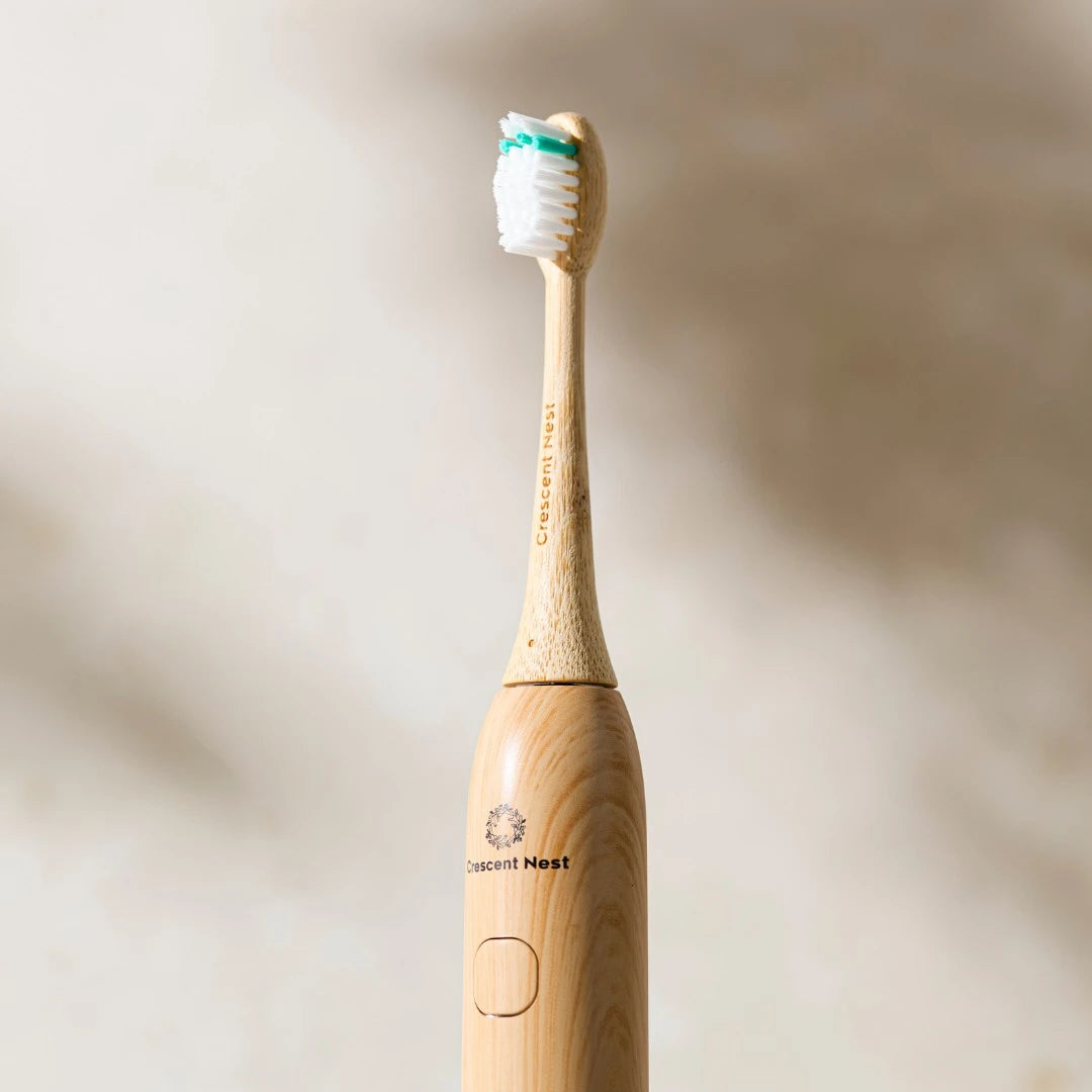 Wooden electric toothbrush with white bristles on a beige background