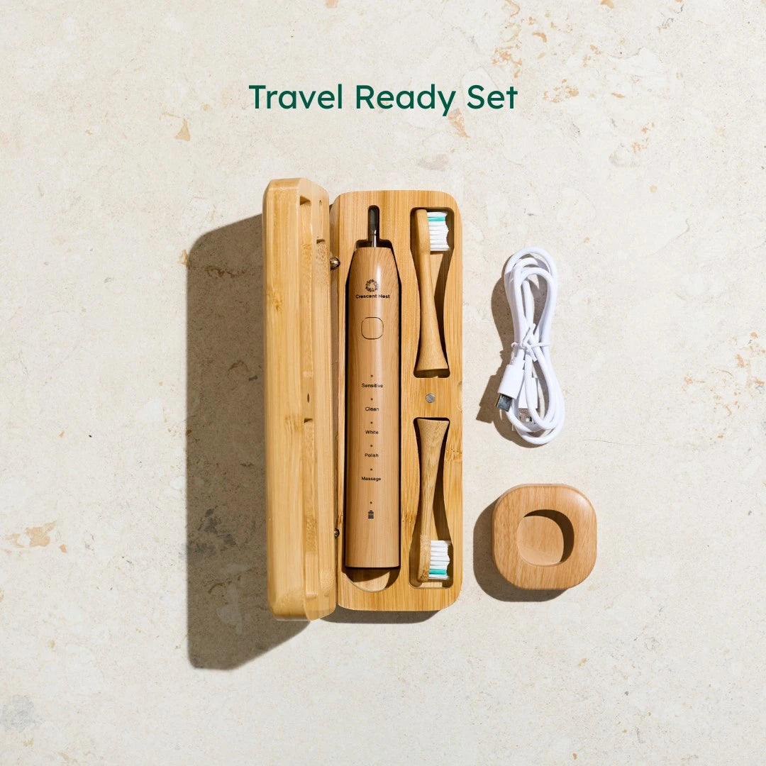 Travel toothbrush set with bamboo case on a beige background