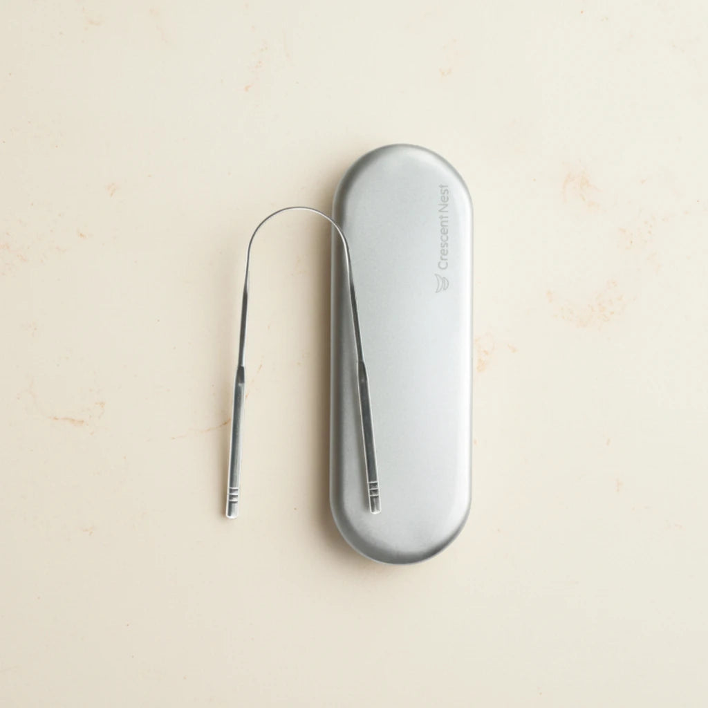 Crescent nest tongue scraper Medical Grade 304 and travel case on a creamy background