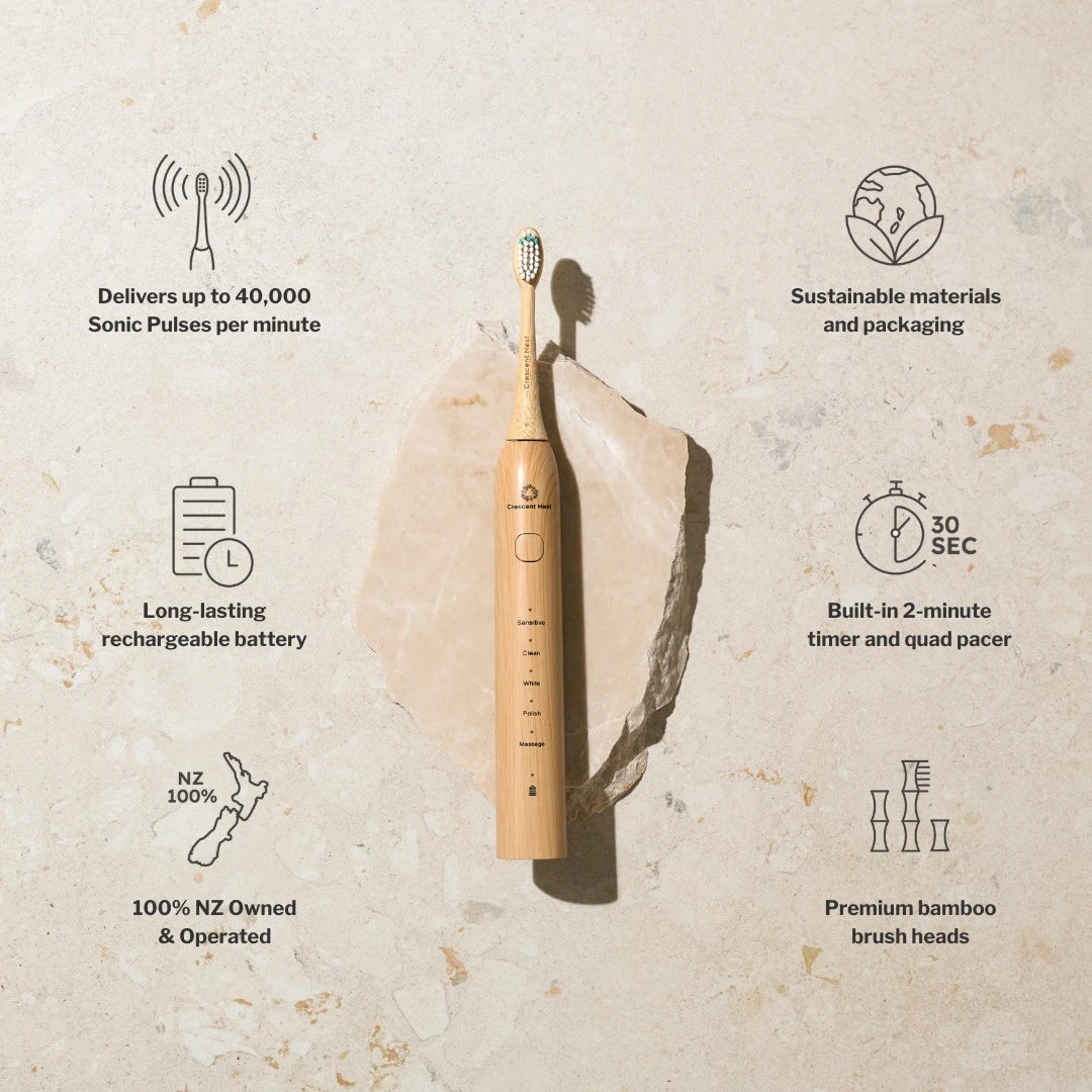 Bamboo toothbrush with sustainability features on a textured beige background