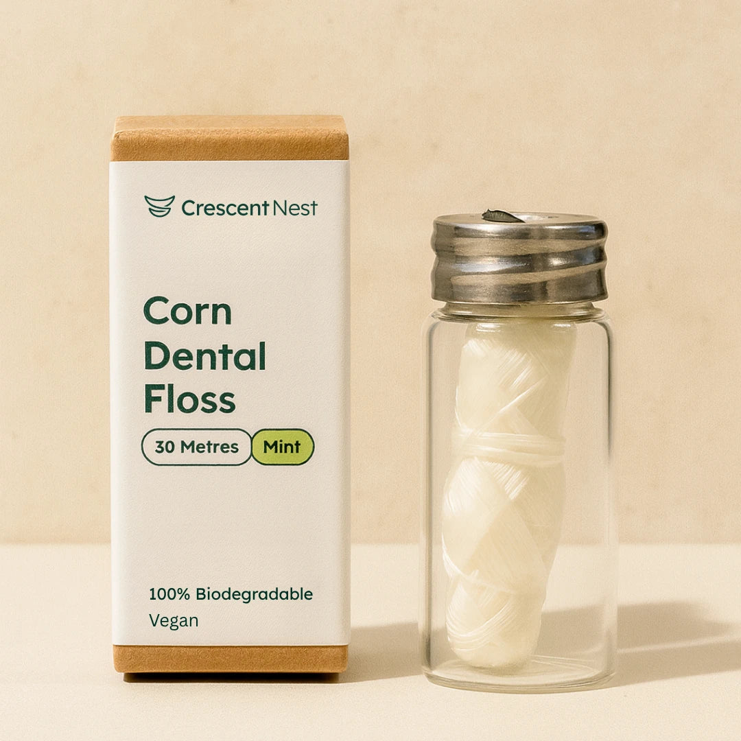 Crescent Nest corn dental floss packaging with a glass container on a beige background