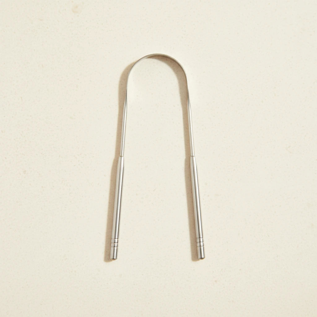 Crescent nest tongue scraper Medical Grade 304 on a creamy background