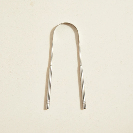 Crescent nest tongue scraper Medical Grade 304 on a creamy background