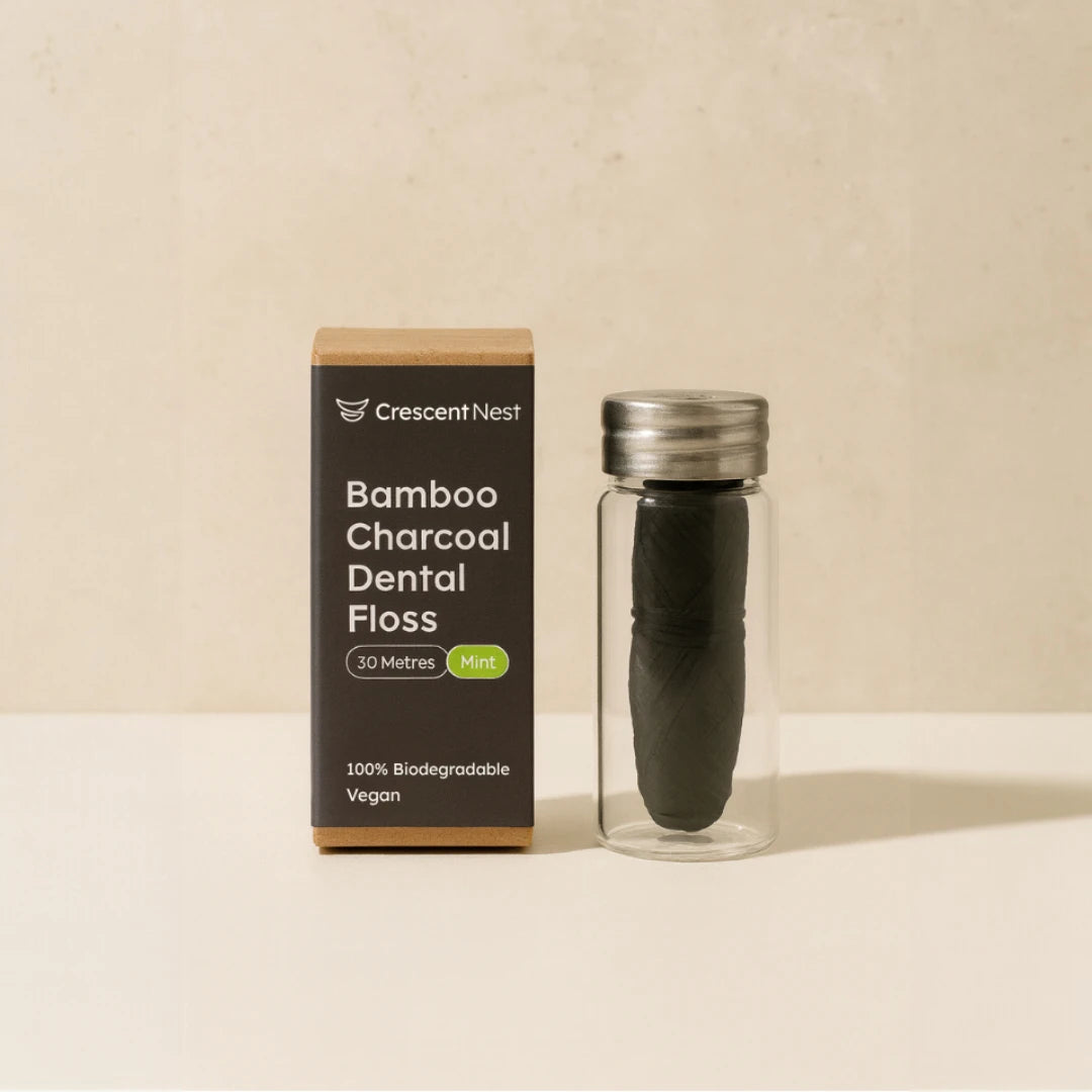Bamboo charcoal dental floss with packaging on a beige background