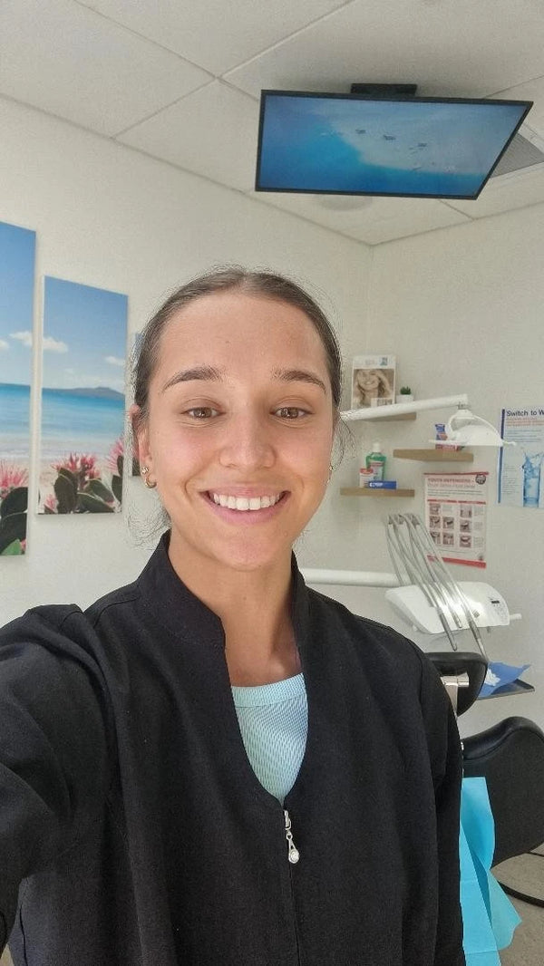 Madison Jade Reid, Oral Health Therapist, holding a Crescent Nest sonic toothbrush
