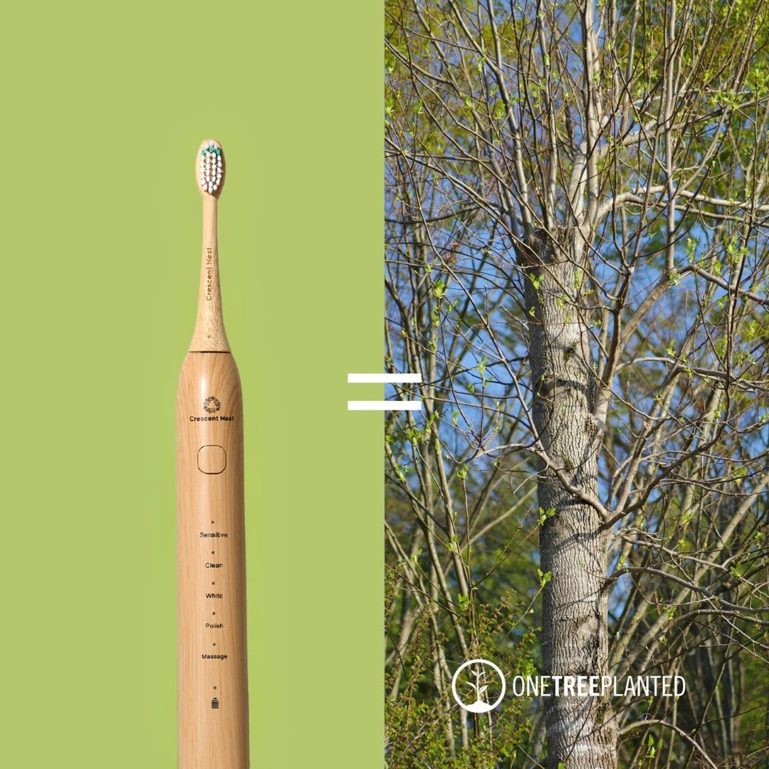 Electric toothbrush with a green background and tree in the background