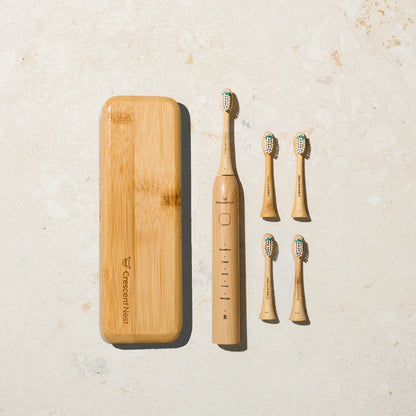 Crescent Nest bamboo electric toothbrush displayed with bamboo travel case and five replacement brush heads.