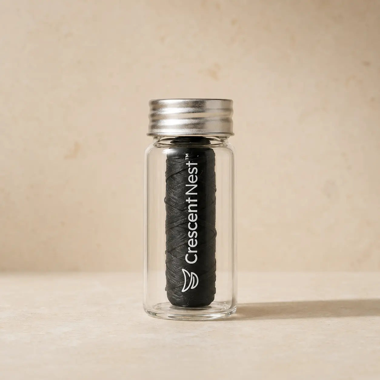 Crescent Nest bamboo charcoal dental floss in a reusable glass jar