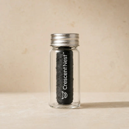 Crescent Nest bamboo charcoal dental floss in a reusable glass jar