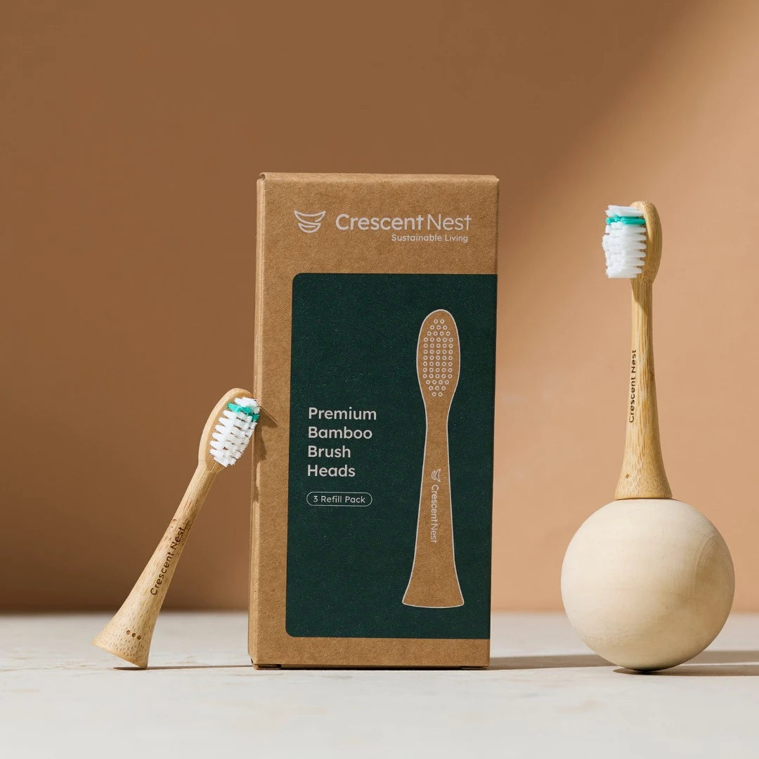 Bamboo toothbrushes and packaging with 'Crescent Nest' branding on a beige background