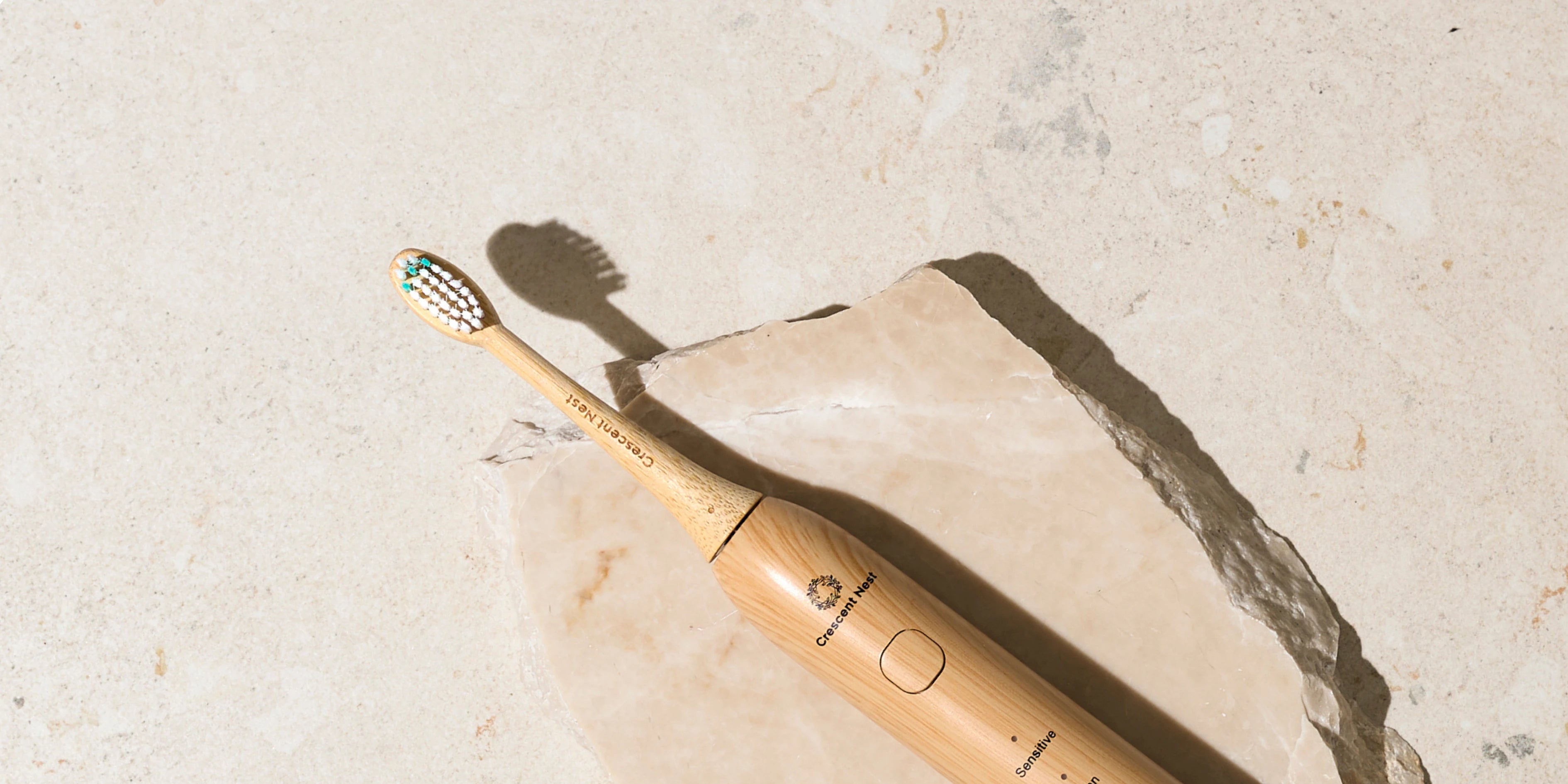 Bamboo toothbrush on a light stone surface