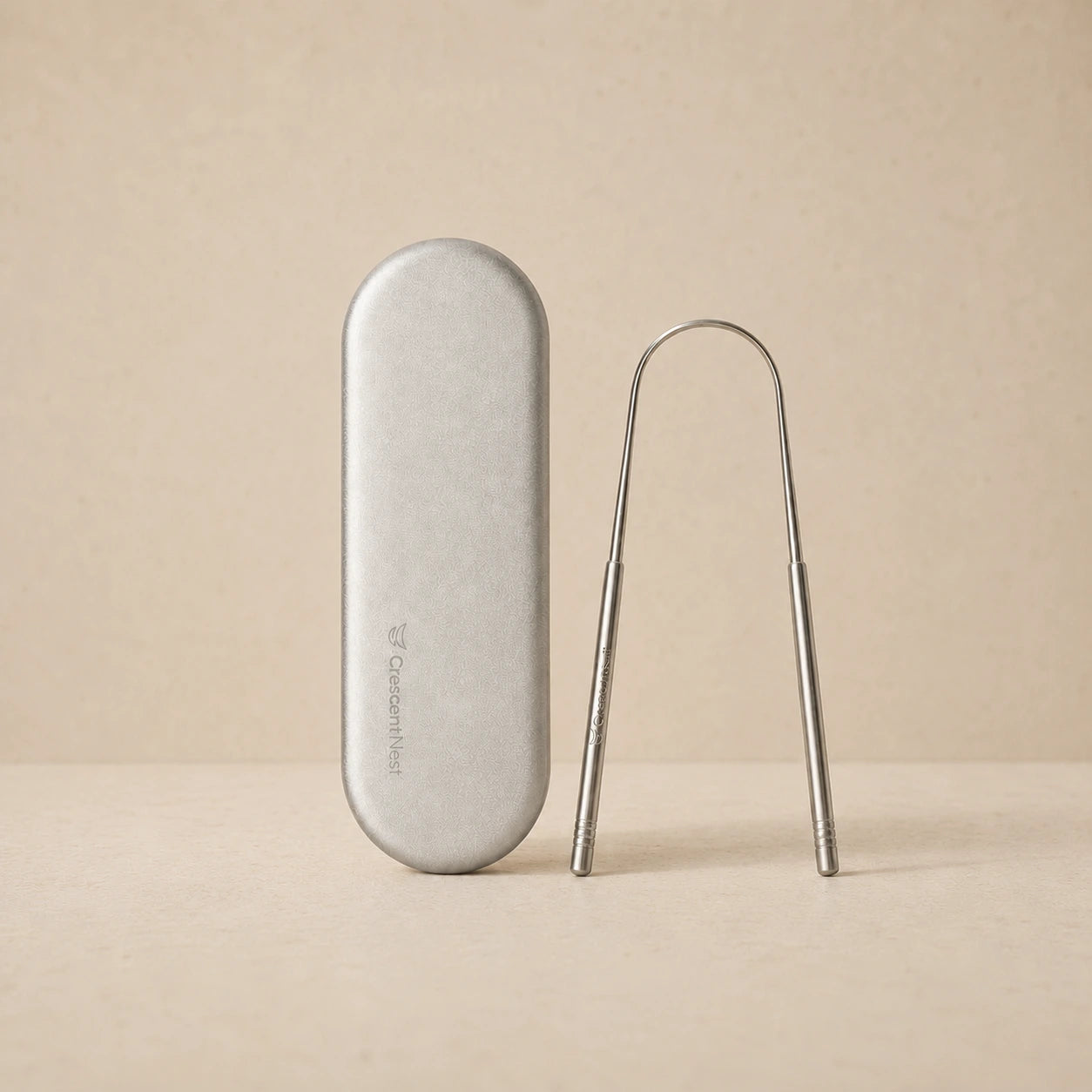 Crescent Nest stainless steel tongue scraper and silver travel case