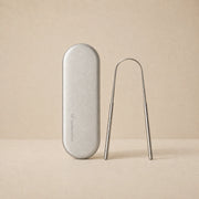 Crescent Nest stainless steel tongue scraper and silver travel case